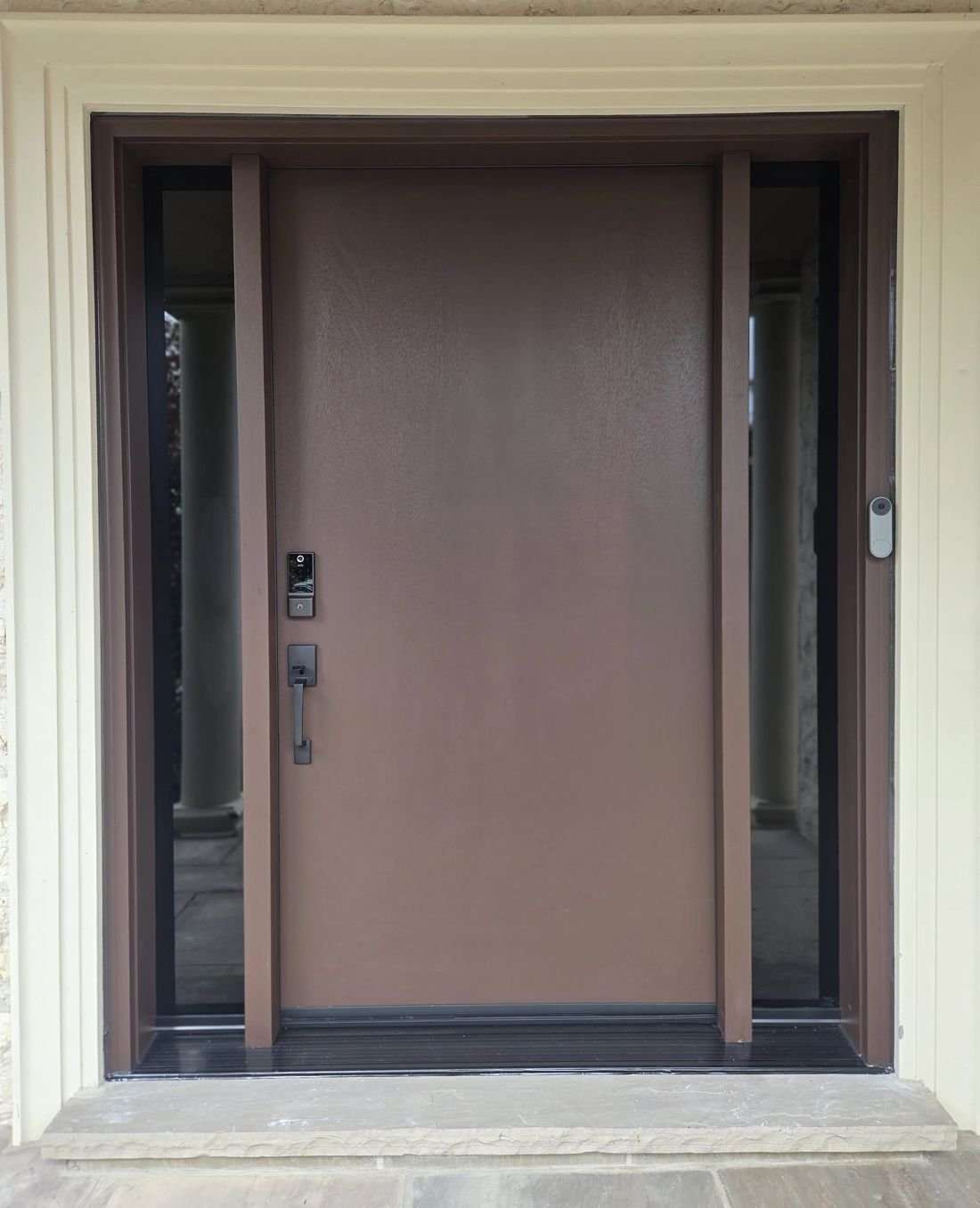 Finished brown front door with sidelites and cream brick mould around the frame