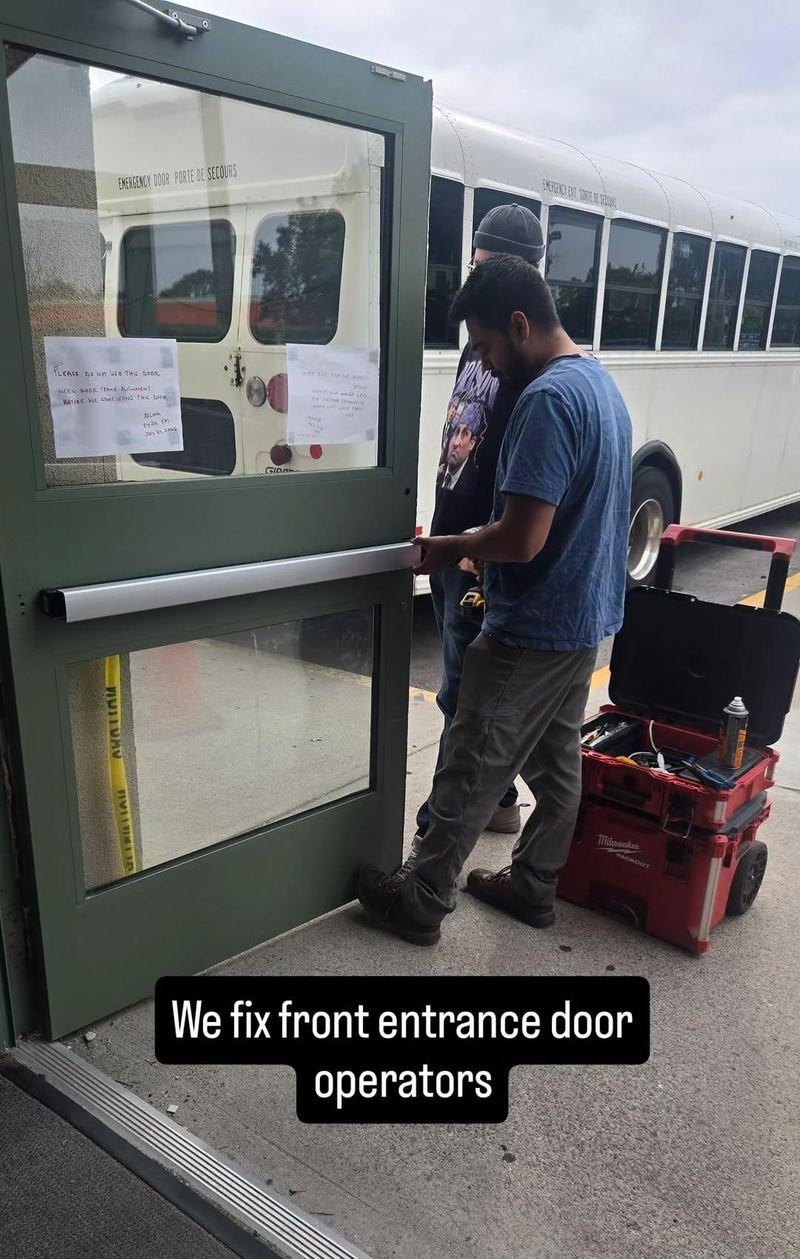 Technician repairing the operator on a commercial entrance door