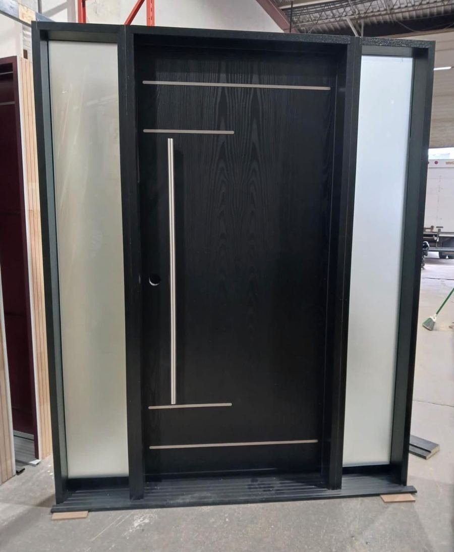 Black front door with frosted sidelites standing in a shop