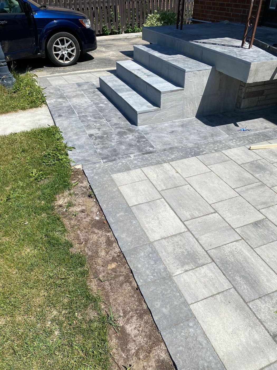 New front steps, landing and interlocking pavers beside a driveway