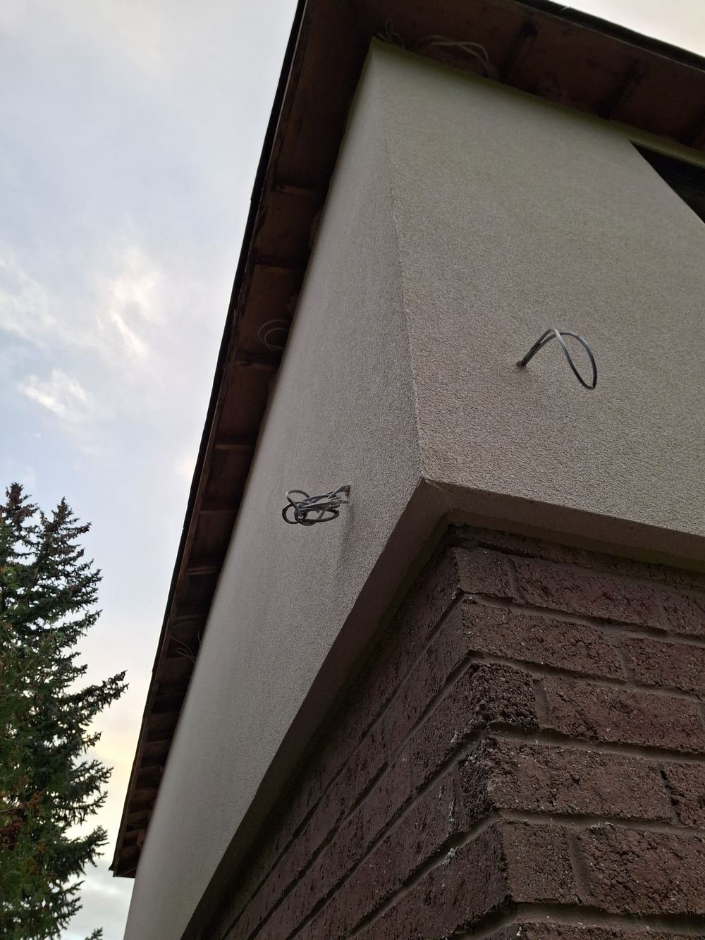 Smooth finished stucco corner above brick