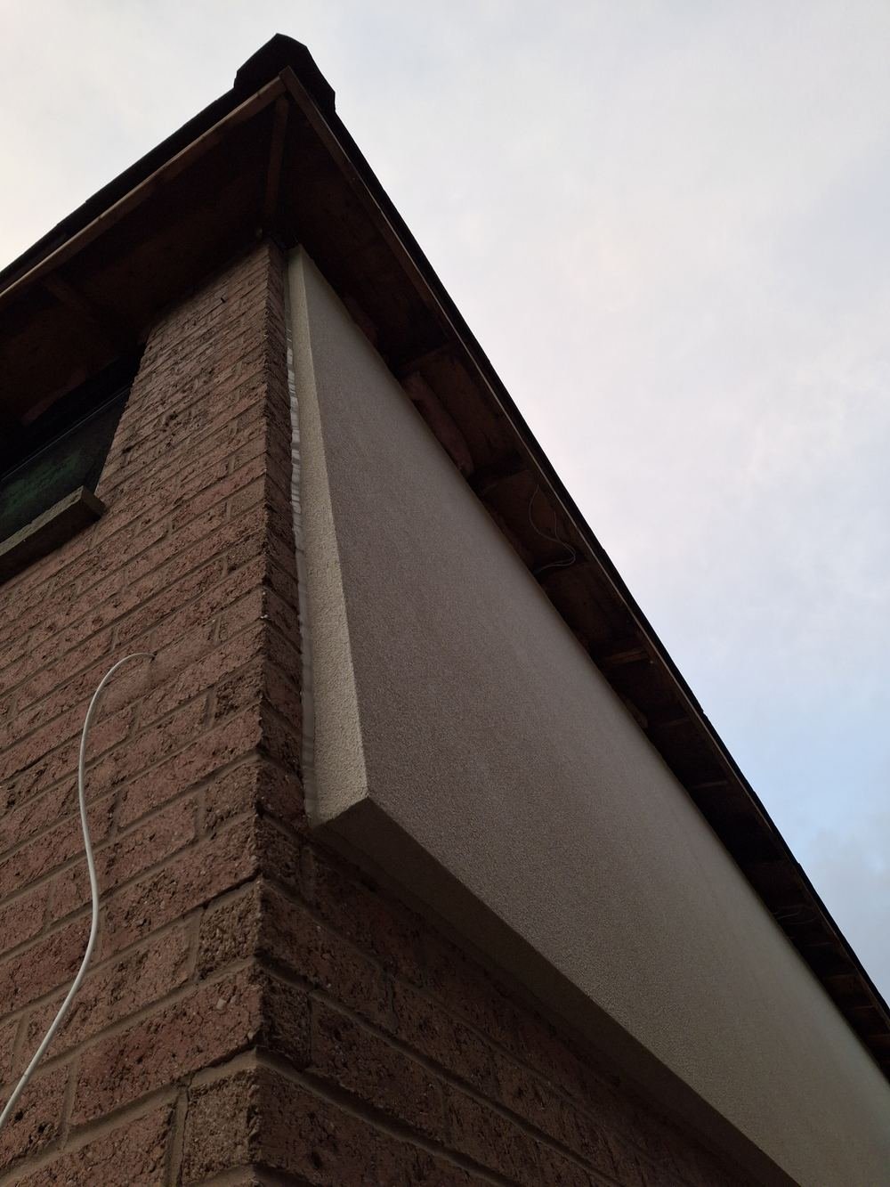 Stucco soffit and brick corner detail